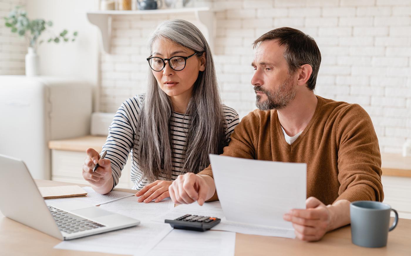 Middle-aged couple sitting at a computer